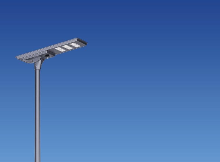 All-in-one solar street light mounted on a pole against a blue sky